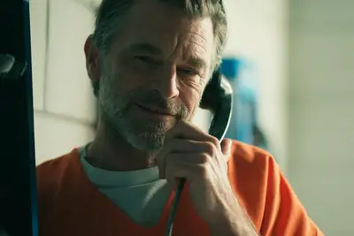 Jimmy holding a phone in prison on 