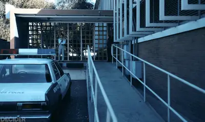 DIAZ AND JUNE STANDING AND SMOKING AGAINST A GRID LIKE A SHOT FROM BETTER CALL SAUL