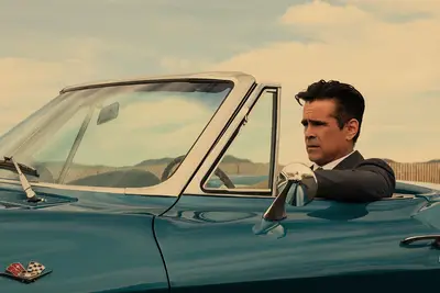 Colin Farrell driving a blue Corvette on 