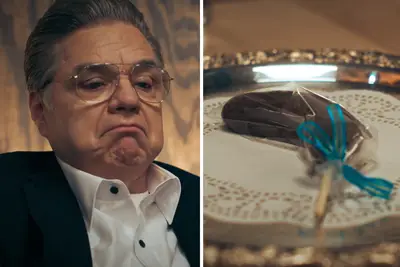 Oliver Platt looking at a chocolate covered banana in 