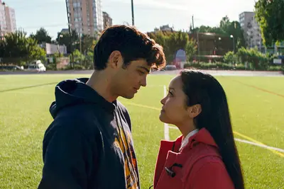Peter (Noah Centineo) and Lara Jean (Lana Condor) stare each other down on the football field.