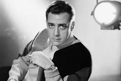 Portrait of Canadian-born American actor Raymond Burr holding a cigarette. 1950s.