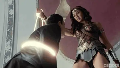 Wonder Woman binds a terrorist in the lasso of truth, but the shot is framed to almost peek up her skirt.