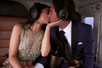 Maria and Joey kissing in a helicopter on 