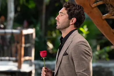 Joey Graziadei holding a rose on 
