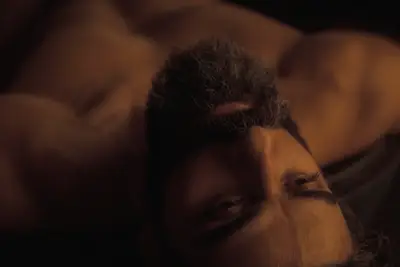Close up of Duke Leto (Oscar Isaac) stripped down, upside down in DUNE