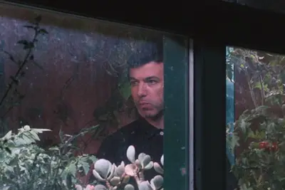 Asher (Nathan Fielder) looking uncomfortable in the garden in 